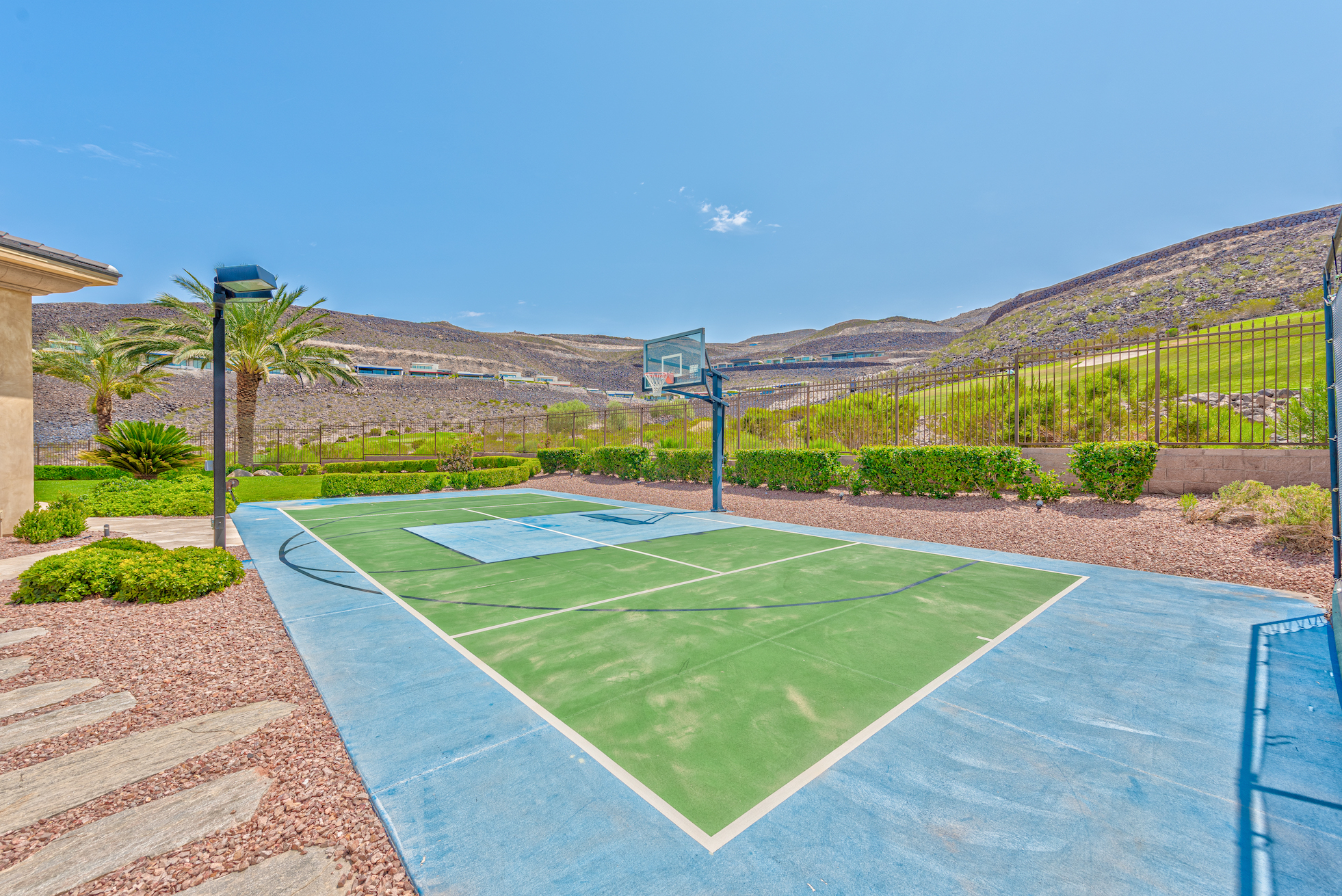 Residential basketball court with desert views.