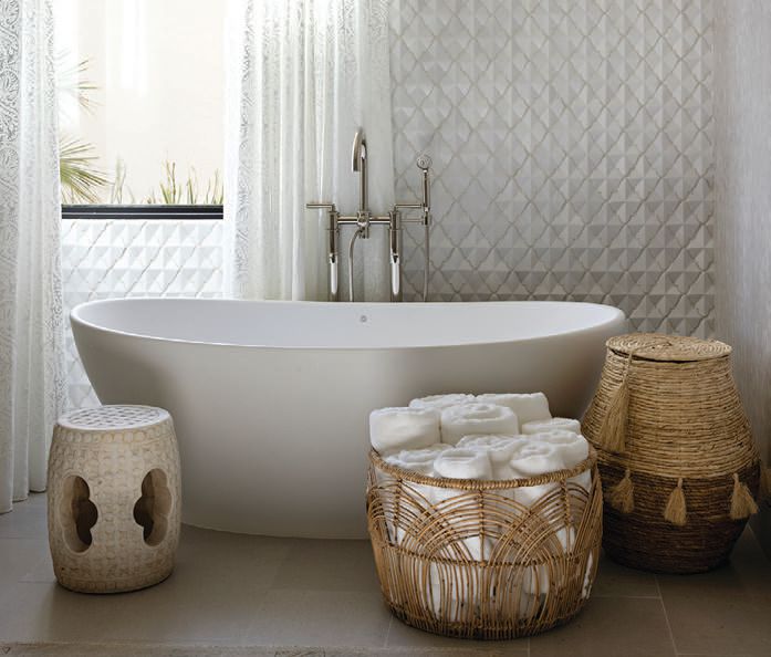 Moroccan-style baskets are both functional and fashionable accents in the primary bathroom as they hold towels and offer storage PHOTOGRAPHED BY KARYN MILLET PHOTOGRAPHY