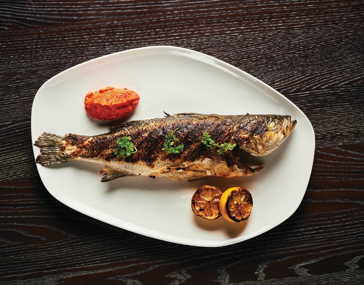 Nine types of fish are offered daily and can be grilled whole or filleted. Here, the whole branzino with Meyerlemon and red pepper and Calabrian chile pesto.  PHOTO COURTESY OF CAESARS PALACE LAS VEGAS