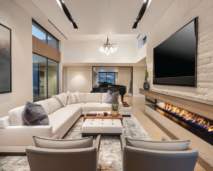 The well-appointed living room is punctuated by a sleek fireplace  PHOTO BY JOHN MARTORANO