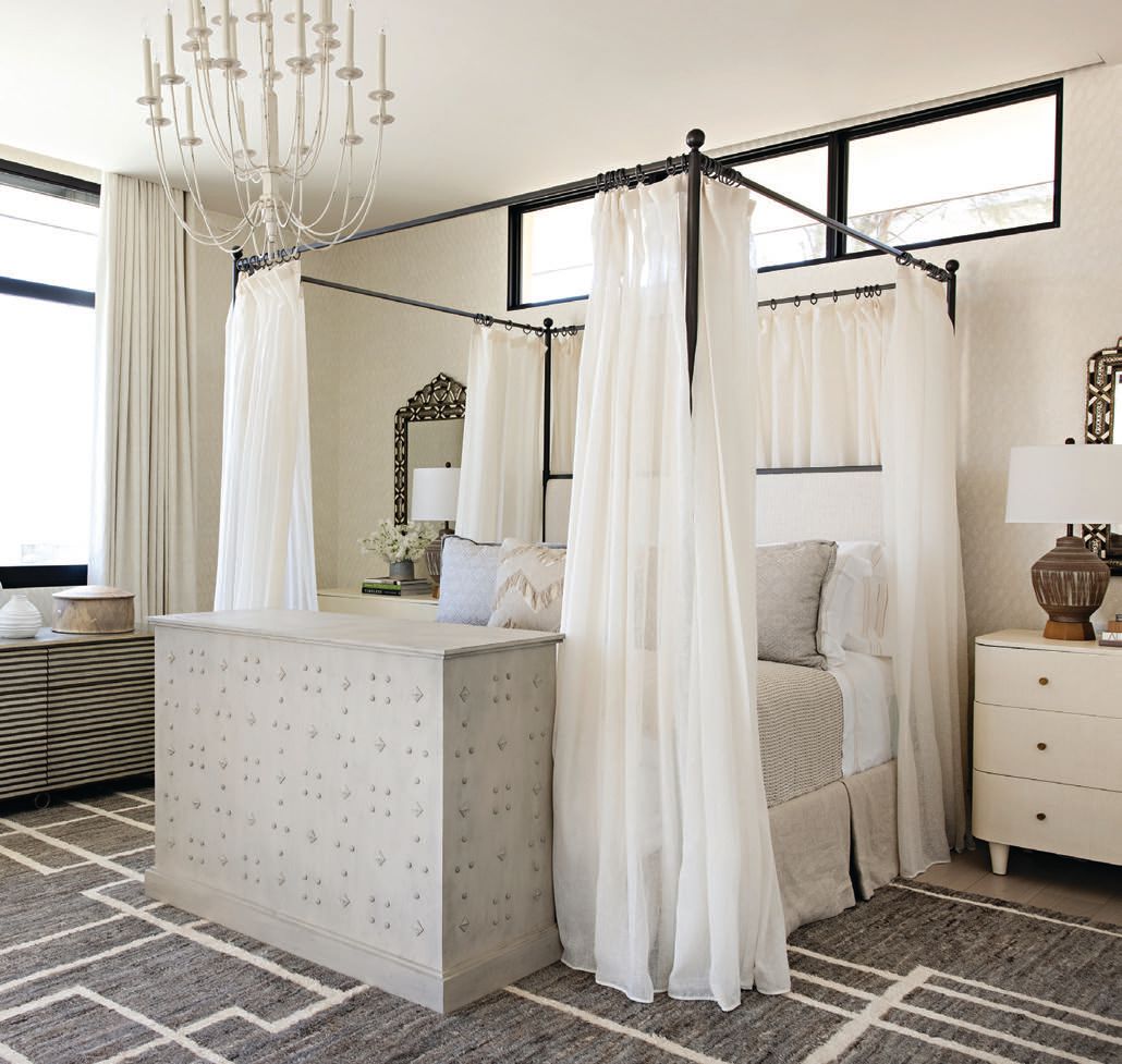 A canopy bed adds whimsical charm to a guest bedroom PHOTOGRAPHED BY KARYN MILLET PHOTOGRAPHY