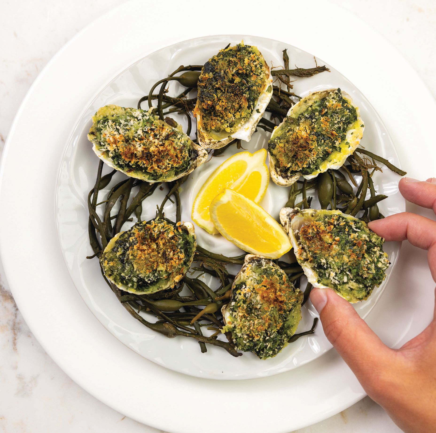 The indulgent oysters Rockefeller includes Pernod cream, spinach, watercress and parsley breadcrumb topping. PHOTO COURTESY OF CAESARS ENTERTAINMENT